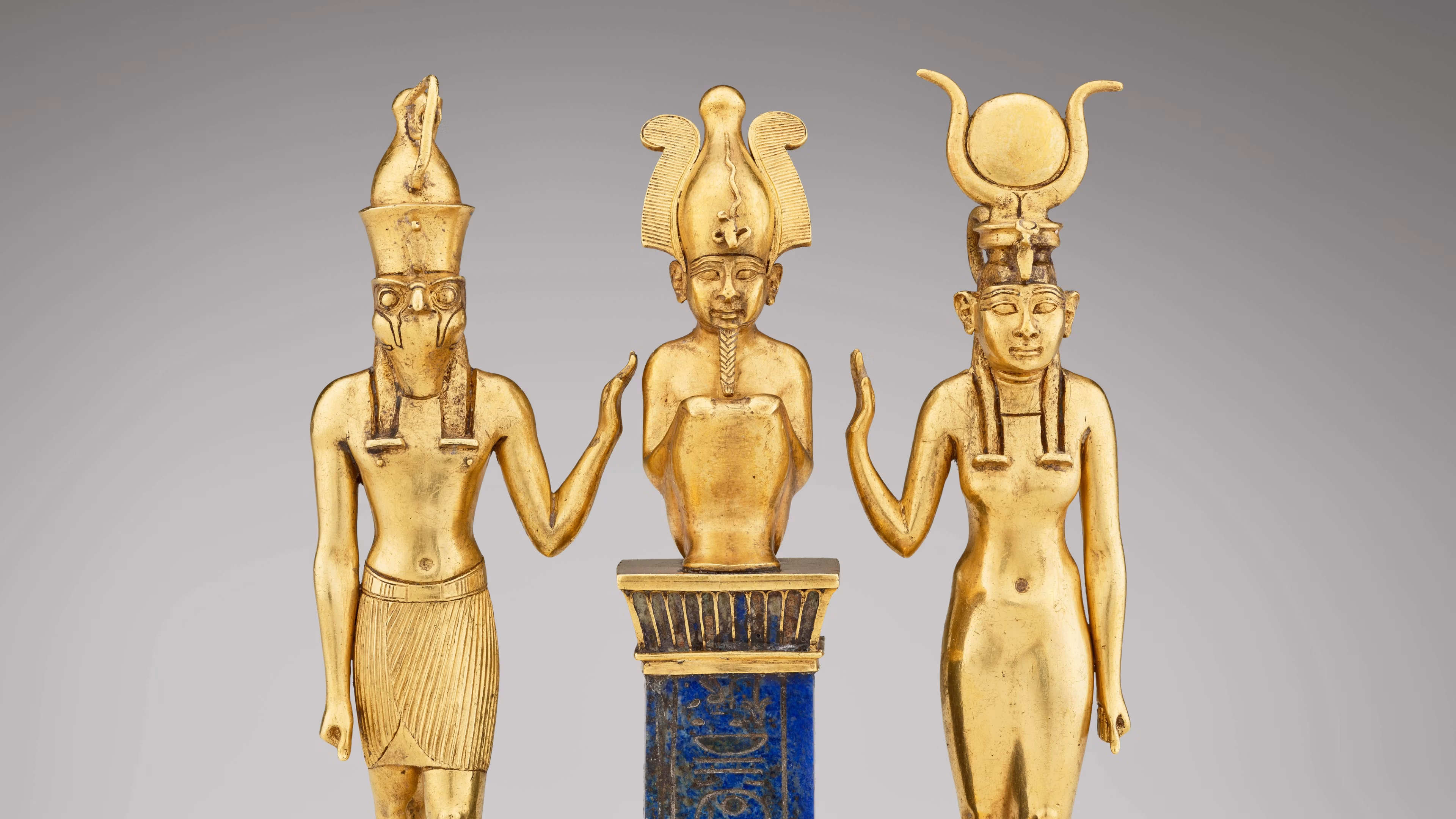 Image credit: Triad of Osiris, Horus, and Isis. From Egypt, probably Thebes, Karnak Temple. Third Intermediate Period, Dynasty 22, reign of Osorkon II (about 872–837 BCE). Gold inlaid with lapis lazuli. Acquired in 1872. Paris, Louvre Museum, Department of Egyptian Antiquities (E 6204). © 2025 GrandPalaisRmn (Louvre Museum). Photo: Mathieu Rabea.