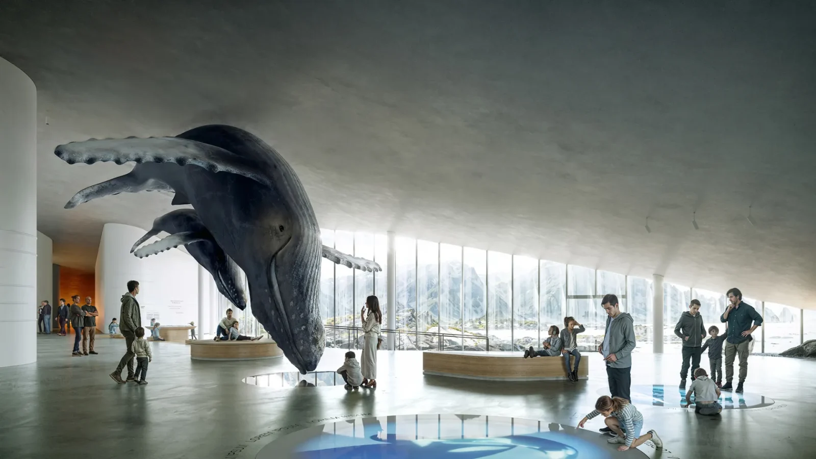 Large suspended whale sculpture in a bright, modern gallery with visitors, benches, and panoramic mountain view windows.